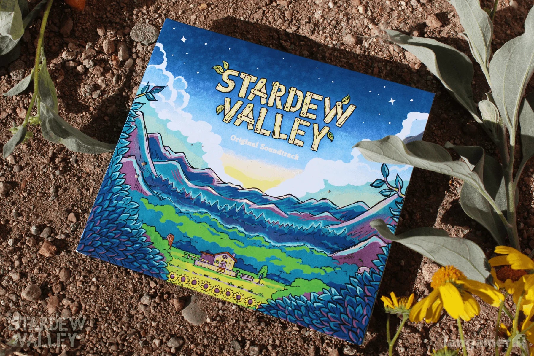 Stardew Valley game case on a dirt surface with plants and flowers.