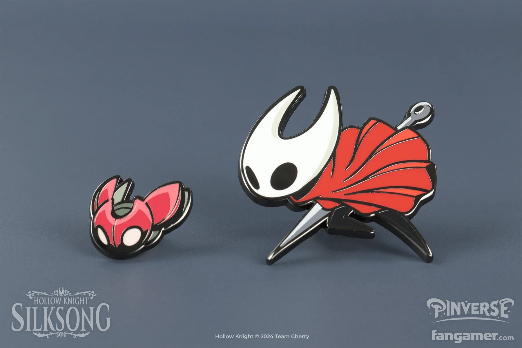 Two enamel pins featuring characters from 'Hollow Knight' on a gray background.