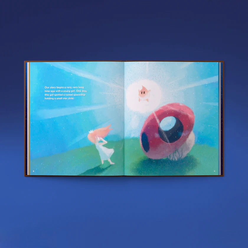 Open book with a colorful illustration of a girl and a large mushroom-like creature on a blue background