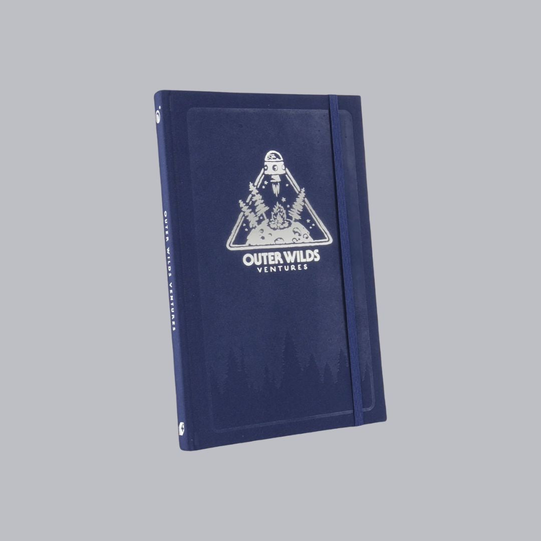 Blue notebook with 'Outer Wilds Ventures' logo on a gray background