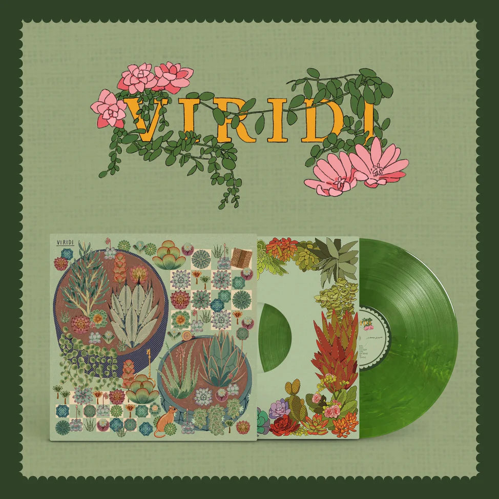 Vinyl record with colorful cover featuring plants and flowers on a green background