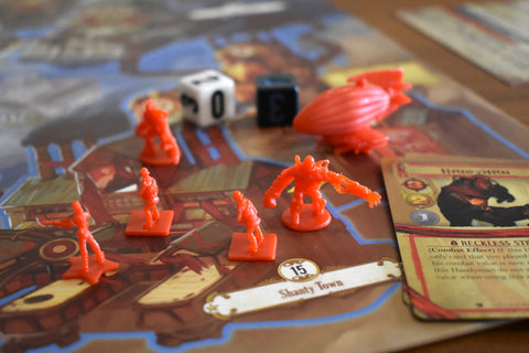 Bioshock board game in play with figurines and dice 